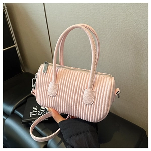 Detail of pink cylindrical Boston bag with unique vertical pleated texture and silver hardware