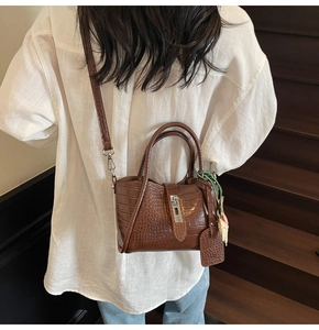 Brown crocodile pattern bucket bag with bear pendant and silk scarf detail
