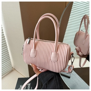 Detail of the pink pleated barrel bag showing the soft texture and silver hardware accents