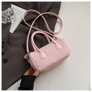 Detail shot of cherry pink pleated Boston bag with vertical textures and slim shoulder strap