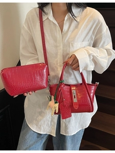 Red crocodile texture handbag and pouch set with metal lock and horse charm on stairs