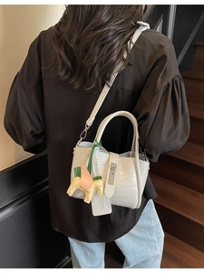 White crocodile pattern bucket bag with silver buckle and yellow pony charm