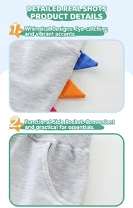 Detail of grey knitted boys shorts featuring 3D dinosaur spine decor and ribbed waistband