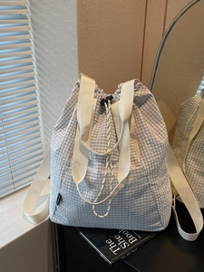 Blue and white checkered drawstring backpack featuring a stylish minimalist texture