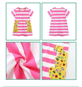 Detail view of pink striped girl's dress with colorful leopard embroidery and soft fabric