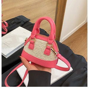 Nahaufnahme der Mini-Tasche mit pinkem Lederbesatz und beiger Webstruktur-Details
