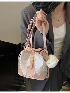 Pink and white jacquard bucket bag with floral patterns and a cute plush charm