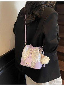 Women's lavender contrast geometric bucket bag with plush charm and gold hardware