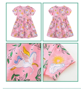 Detail view of pink girls dress with unicorn patterns and high-quality stitching detail