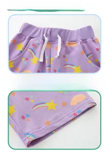 Detail of girls purple shorts with rainbow prints, elastic waist, and white drawstring
