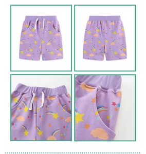 Detail view of purple girls' rainbow shorts featuring elastic waist and stitching details