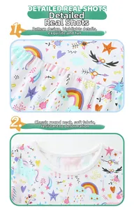 Detail of soft white cotton dress featuring colorful unicorn and rainbow cartoon prints
