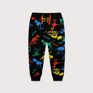 Detail of kids black joggers featuring colorful dinosaur skeleton prints and orange drawstring