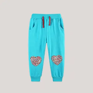 Detail of lake blue kids joggers with contrast drawstring and floral heart patches