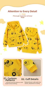 Detail view of yellow hooded sweatshirt with cartoon excavator prints and ribbed cuffs