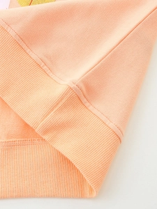 Girl's peach cotton sweatshirt with ribbed hem and golden glitter heart print