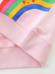 Pink cotton girls' sweatshirt featuring a vibrant rainbow smile print and ribbed cuffs