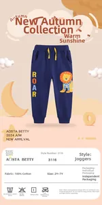 Detail of navy boy's knit joggers with yellow ROAR text and cartoon lion print