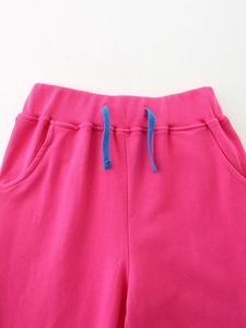 Girls' vibrant rose red sports pants with elastic waistband and blue drawstring detail
