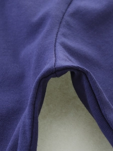 Close-up of durable purple knitted fabric stitching on kids long sleeve t-shirt