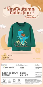 Detail of green cotton toddler tee featuring a cartoon dinosaur riding a bike print