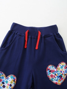 Girls' navy cotton joggers featuring floral heart patches and a red decorative drawstring