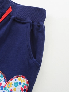 Girls navy knit joggers with elastic drawstring waist and heart floral patch details