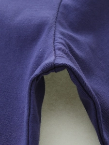 Detailed macro view of dark blue cotton knit fabric with durable reinforced stitching seams