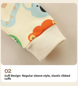 Close-up of elastic ribbed cuffs on a beige toddler hoodie with cartoon dinosaur prints