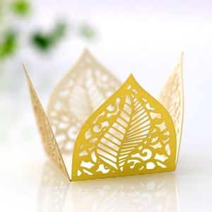 Macro detail of laser-cut gold leaf pattern with metallic luster for party favors