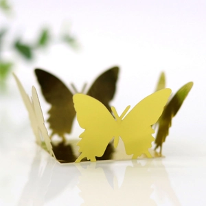 Macro shot of mirror gold butterfly candy box with intricate cut-out lace design