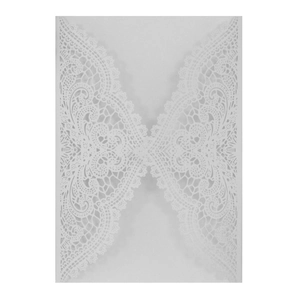 Detailed laser cut lace pattern on white wedding invitation card with floral hollow design