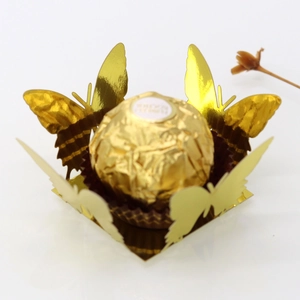 Detailed view of laser-cut gold butterfly chocolate wrapper and hollow favor box