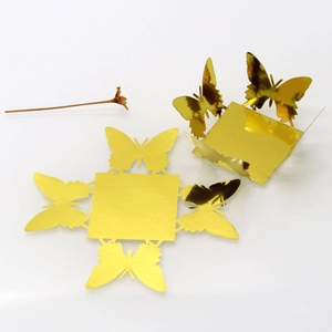 Detailed macro view of laser-cut butterfly candy box made of gold mirror cardstock