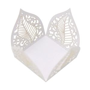 Detailed laser-cut leaf pattern on white pearlescent paper cupcake wrapper for weddings