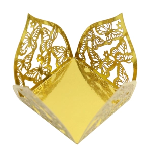 Detail view of laser-cut gold butterfly favor box for wedding and party decorations
