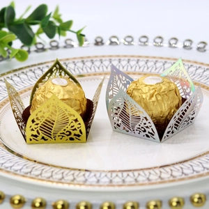 Close-up of laser-cut gold and purple leaf-shaped hollowed chocolate paper lace liners