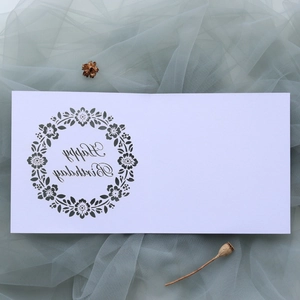 Close-up of laser-cut Happy Birthday card with intricate wreath design on blue tulle
