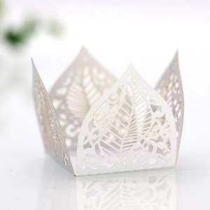 Detail view of laser-cut crown hollow leaf candy box with white pearlescent paper texture