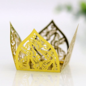 Detailed view of laser-cut gold butterfly pattern on crown-shaped wedding candy box