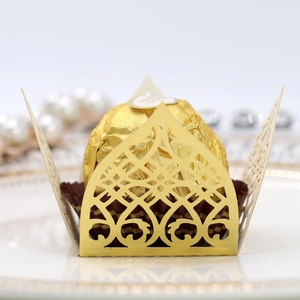 Detailed close-up of golden laser-cut hollow chocolate wrappers with elegant crown patterns
