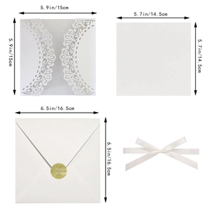Laser-cut wedding invitation set with dimensions showing white lace cover and silk ribbon