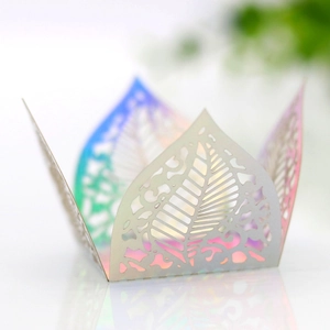 Detailed macro view of iridescent white laser-cut leaf pattern on wedding candy box