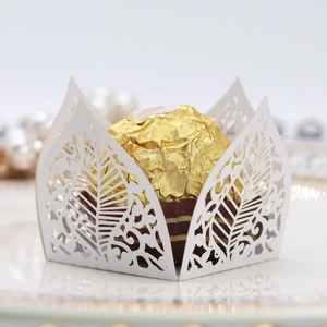 Macro detail of white laser-cut leaf patterns on a chocolate decorative gift box