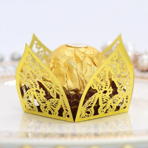Detail of laser-cut butterfly chocolate box in metallic gold with hollow lace design
