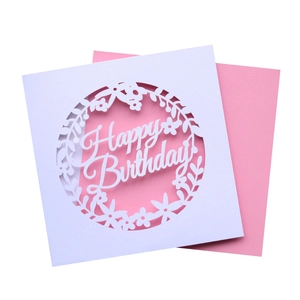 Detail of laser-cut Happy Birthday card with intricate floral patterns and pink insert