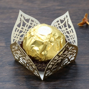 Close-up of laser-cut hollow candy box with elegant white paper lace and chocolate