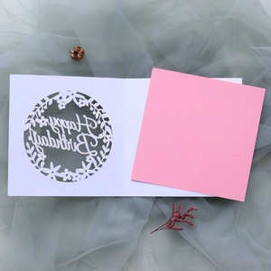 Close-up of laser-cut Happy Birthday card with pink insert on elegant mesh background