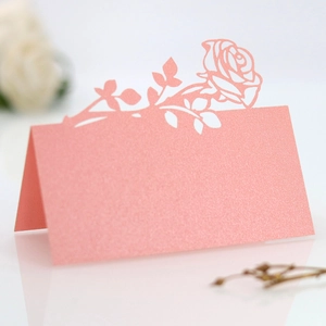 Laser-cut pink pearl paper place card with rose design for wedding table setting