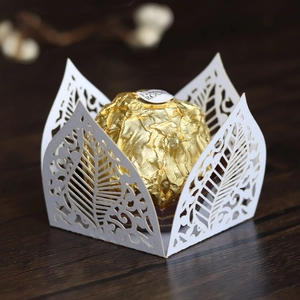 Detail of white laser-cut leaf pattern chocolate box with pearl paper texture